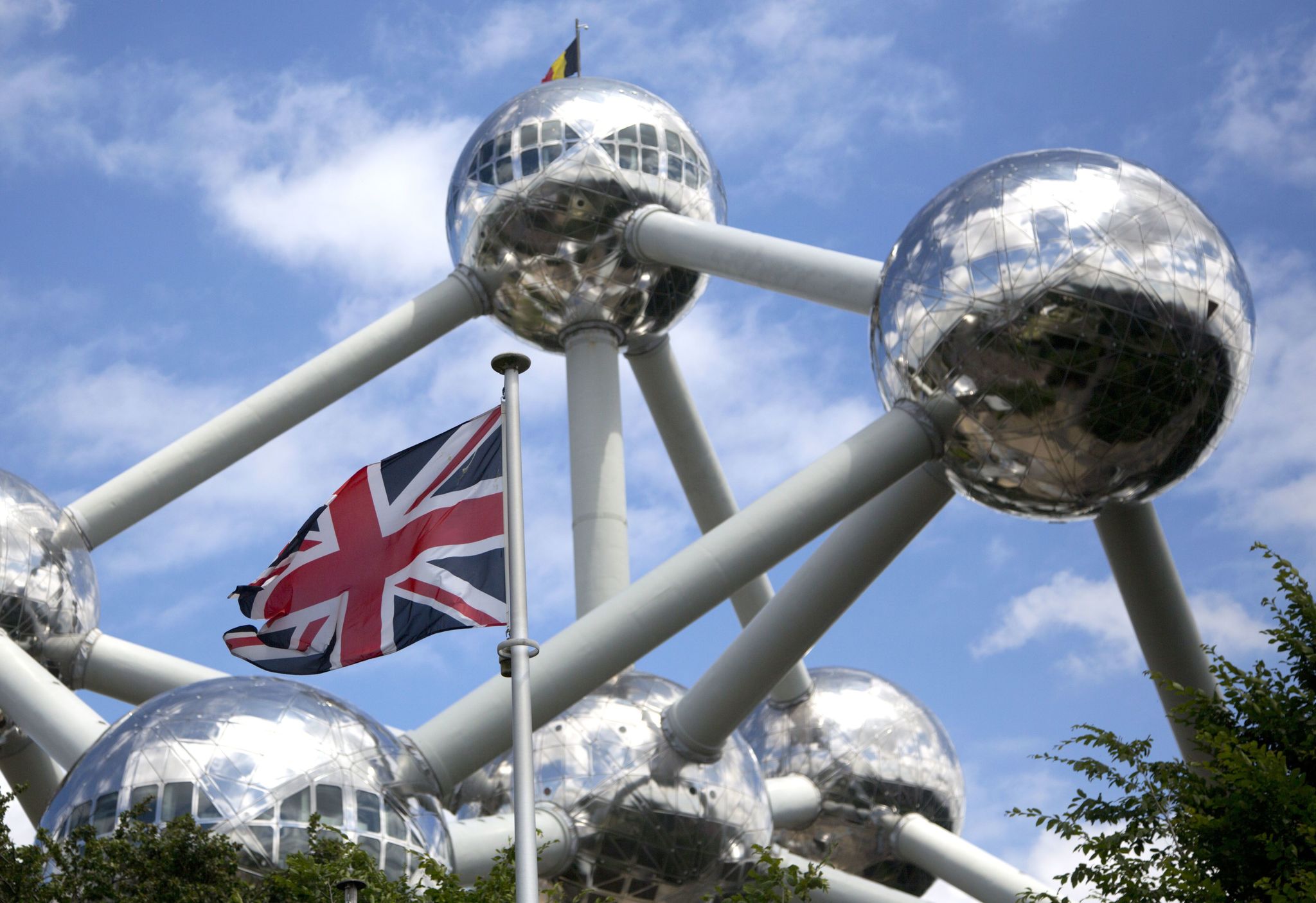 The British flag flutters in the wind in front of a model of the Brussels Atomium construction at the Mini-Europe park in Brussels on Wednesday. British voters go to the polls on Thursday for a national referendum to vote whether to leave or stay in the EU.