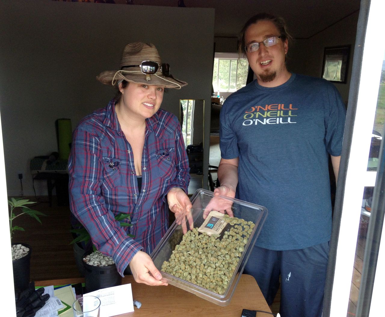 Marijuana growers Christopher and wife Lindsey Pate, licensed cannabis providers in the state of Oregon that produce medical cannabis, hold a tray of their marijuana in Redmond, Ore., on Thursday. Dozens of communities and about half of Oregon’s counties have banned recreational pot shops as allowed under state law, but a group of pot activists are asking voters in two counties on May 17 to overturn the opt-outs. More communities and counties will be voting on similar measures in the general election in November.