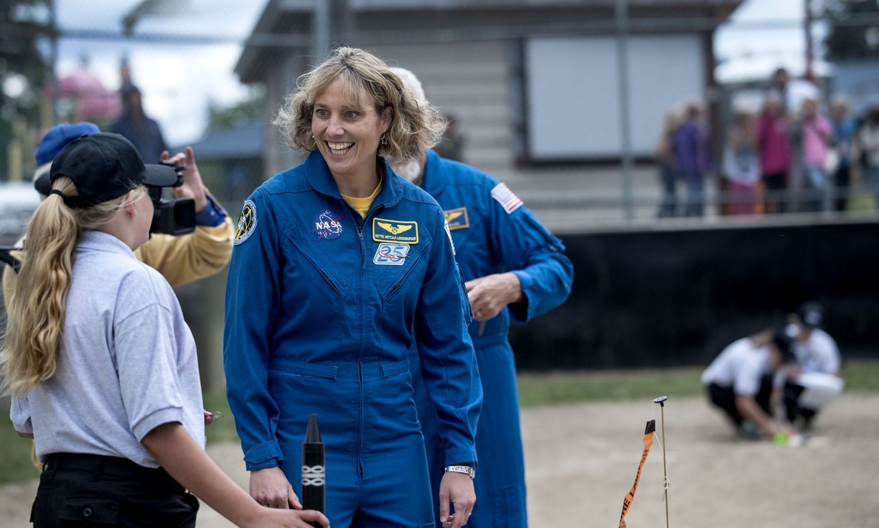 Astronaut Dorothy Metcalf-Lindenburger, of Seattle, talks with Addisen Kingery before launching several rockets at Priest River Elementary School, Idaho, on May 15.