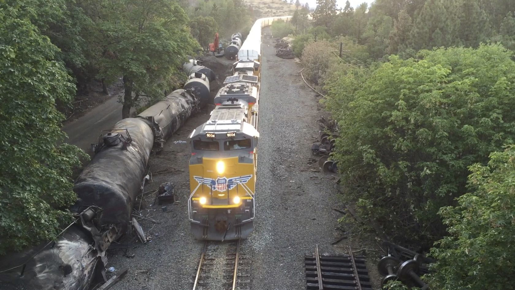 This June 6 photo taken from a drone shows crumpled oil tankers lying beside the railroad tracks after a fiery train derailment on June 3 that prompted evacuations from the tiny Columbia River Gorge town about 70 miles east of Portland in Mosier, Oregon.