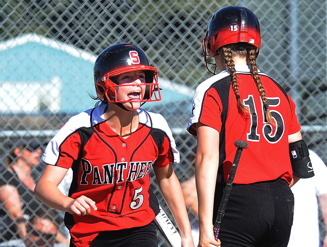 Snohomish’s Sami Reynolds (left) celebrates with teammate Rylie Wales after Reynolds’ scored one of Snohomish’s four runs in a 4-0 in over Jackson on May 10 at Snohomish High School.