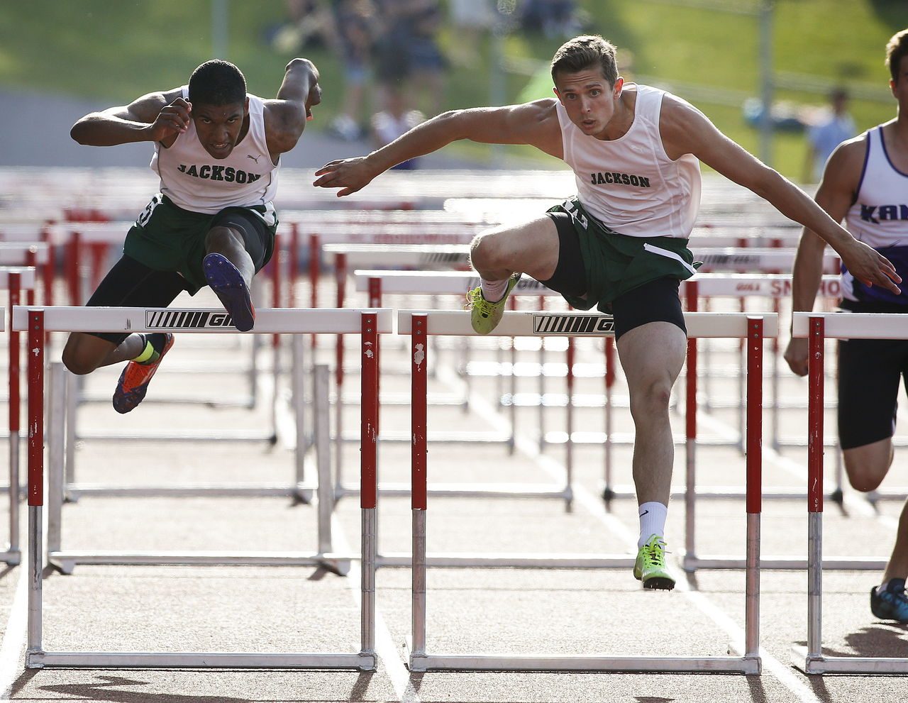 Jackson’s Dylan Roy (right) edges out teammate Silas Vega-Harris (left) for the win in the boys 110-meter hurdles at the Wesco 4A league championships on Friday at Snohomish High School.