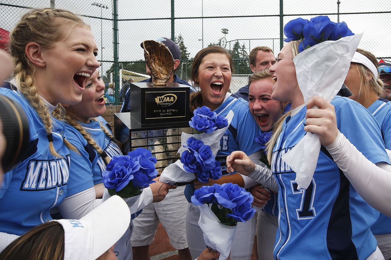 Meadowdale players (from left) Kaylee Williams, Lauren Dent, Julia Reuble, Emma Helm and Savanna Spratt celebrate the Mavericks’ 10-0 victory over Enumclaw in the Class 3A state softbal game in Lacey on Saturday.