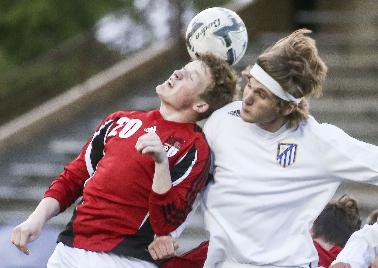 Snohomish’s Jason Fairhurst (left) and Tahoma’s Wesley McClure jump for a header during a 4A state semifinal match Friday night at Sparks Stadium in Puyallup.