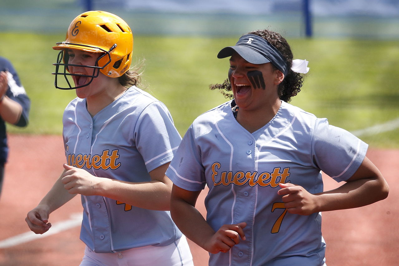 Everett teammates Megan Gordon (left) and Alexis Rutter celebrate a run during a game against Auburn Mountainview in the first round of the 3A state softball tournament Friday in Lacey. Everett won 8-3.