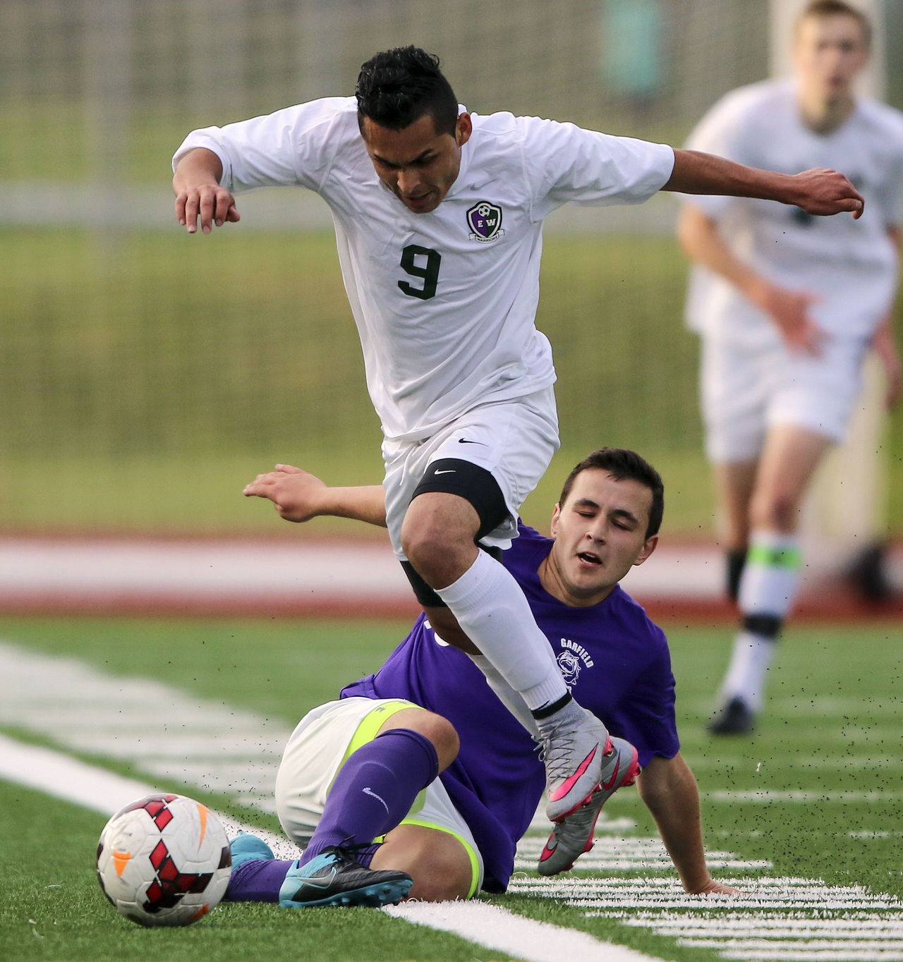 Edmonds-Woodway’s Jose Aleman-Cruz (9) is tackled by Garfield’s Aidan Chestnut during a 3A state tournament match on May 20 at Edmonds Stadium.