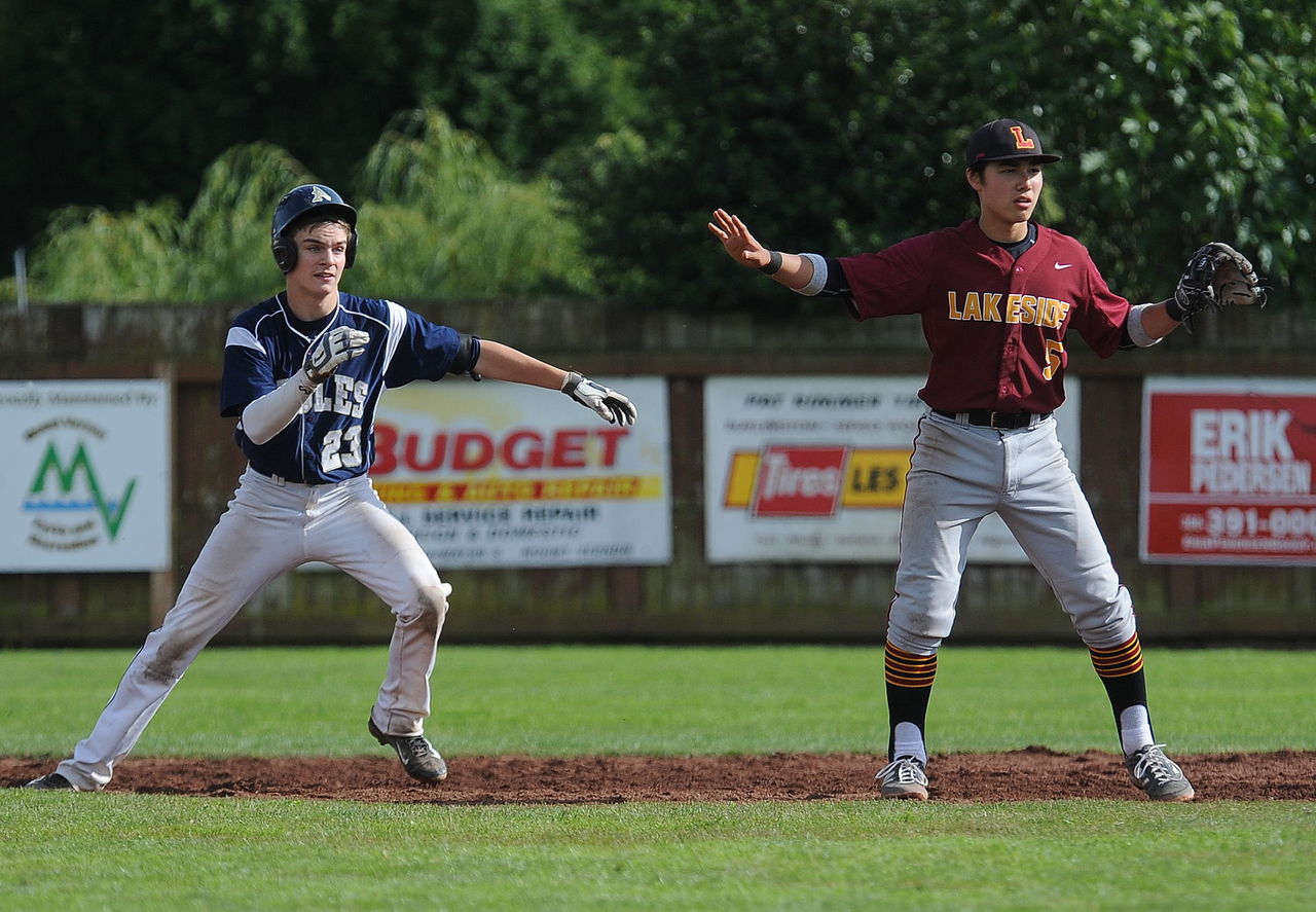 Arlington’s Jack Sheward (left) retreats back to second base as Lakeside shortstop Zane Baker looks for the throw during the fourth inning of Sunday’s Class 3A regional championship game.
