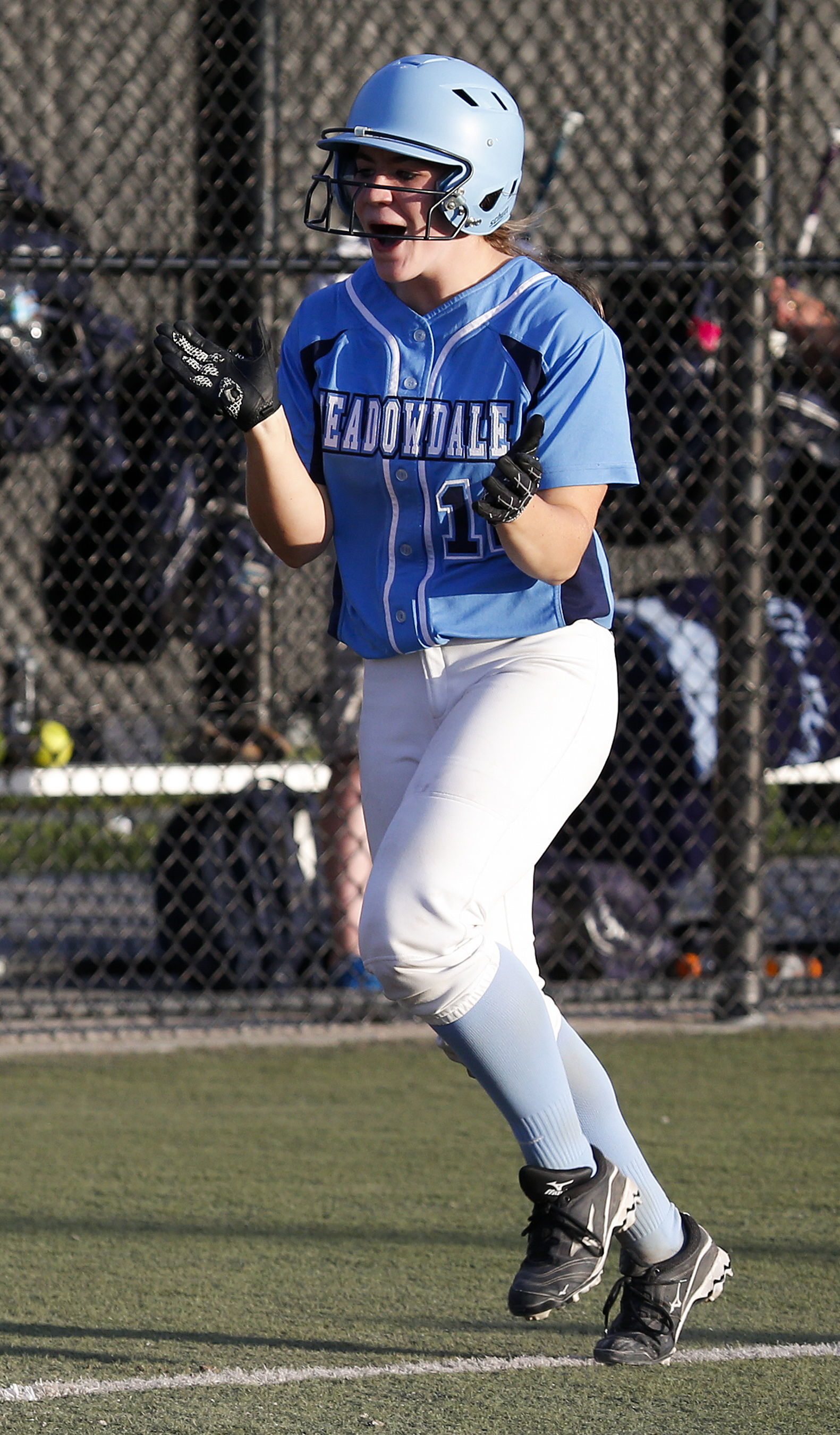 Meadowdale’s Emma Helm cheers as she rounds the bases after hitting a home run during a 3A District 1 semifinal game against Marysville Pilchuck on May 17 in Everett.