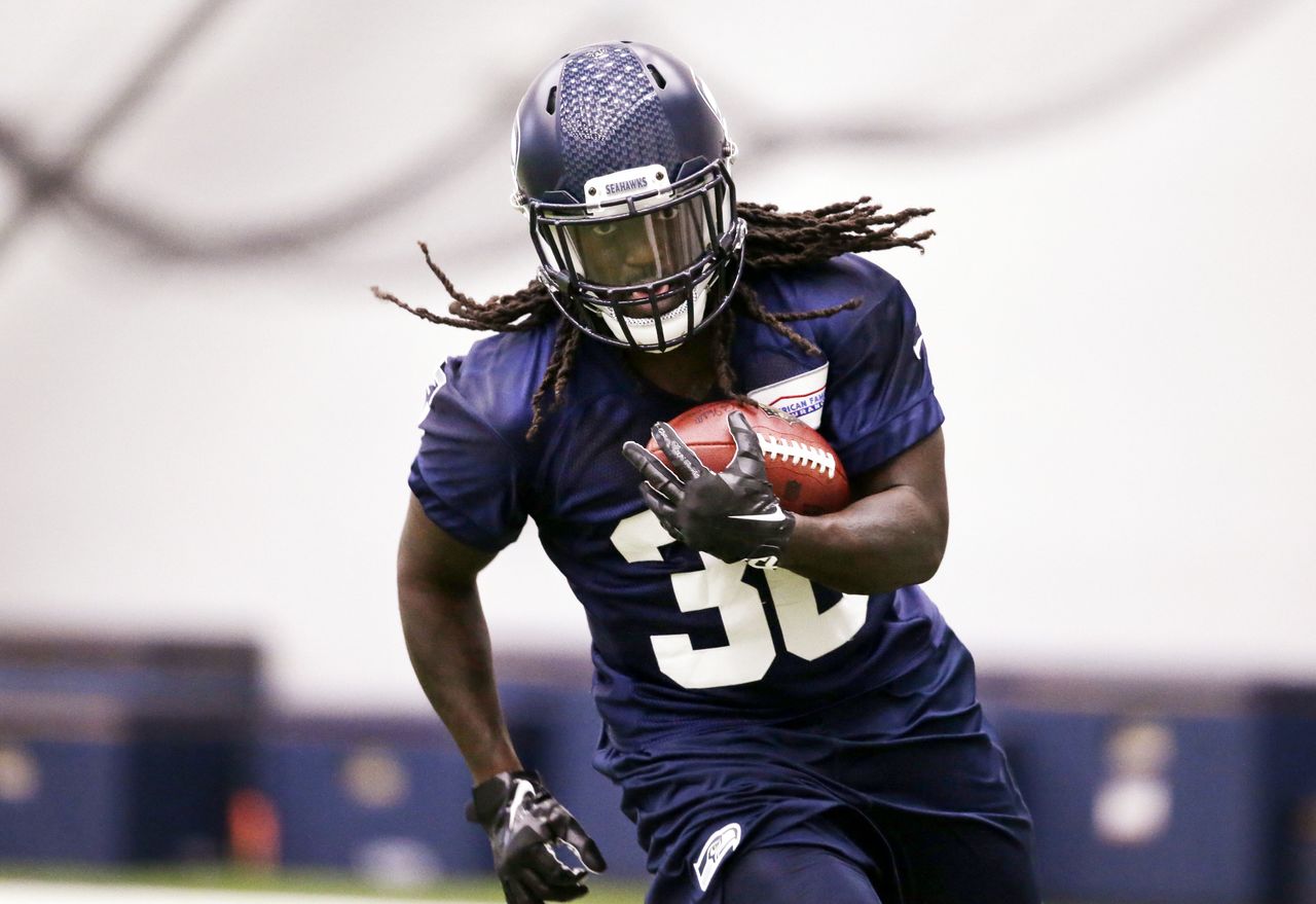 Seahawks running back Alex Collins, a fifth-round draft pick from Arkansas, runs with the ball during Sunday’s rookie minicamp practice in Renton.
