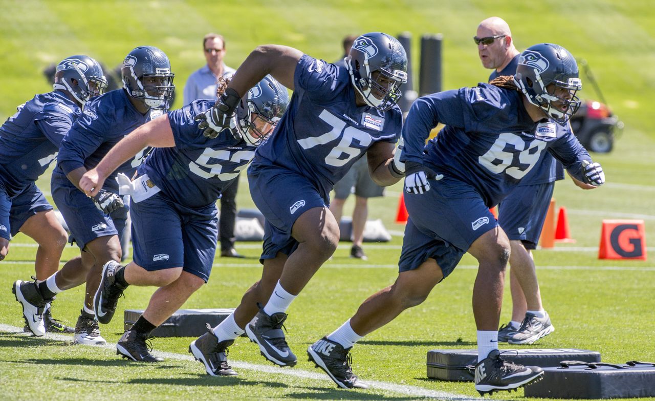 Offensive lineman Germain Ifedi (center) runs a drill in practice during Seahawks rookie minicamp Friday afternoon in Renton. He is following tackle Terry Poole and followed by center Joey Hunt.
