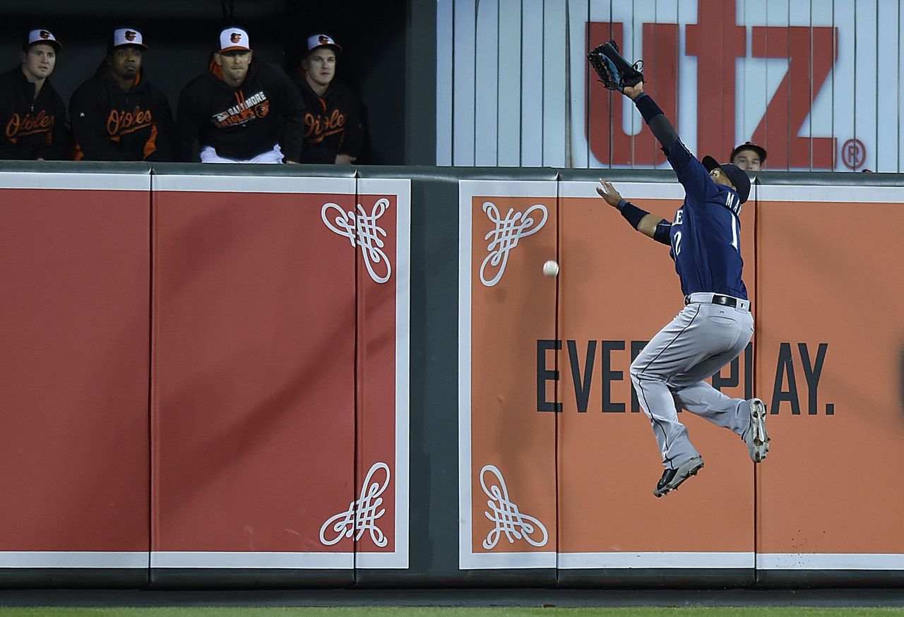 Mariners center fielder Leonys Martin leaps and misses an RBI double hit by the Orioles’ Matt Wieters in the fourth inning of Wednesday’s game.