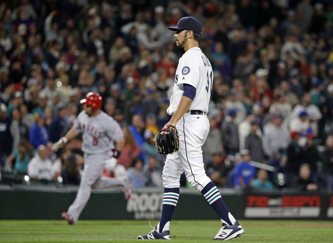 Mariners relief pitcher Steve Cishek looks on as the Angels’ Albert Pujols rounds third base after hitting a three-run home run in the top of the ninth inning inning to give Los Angeles a 9-7 lead.