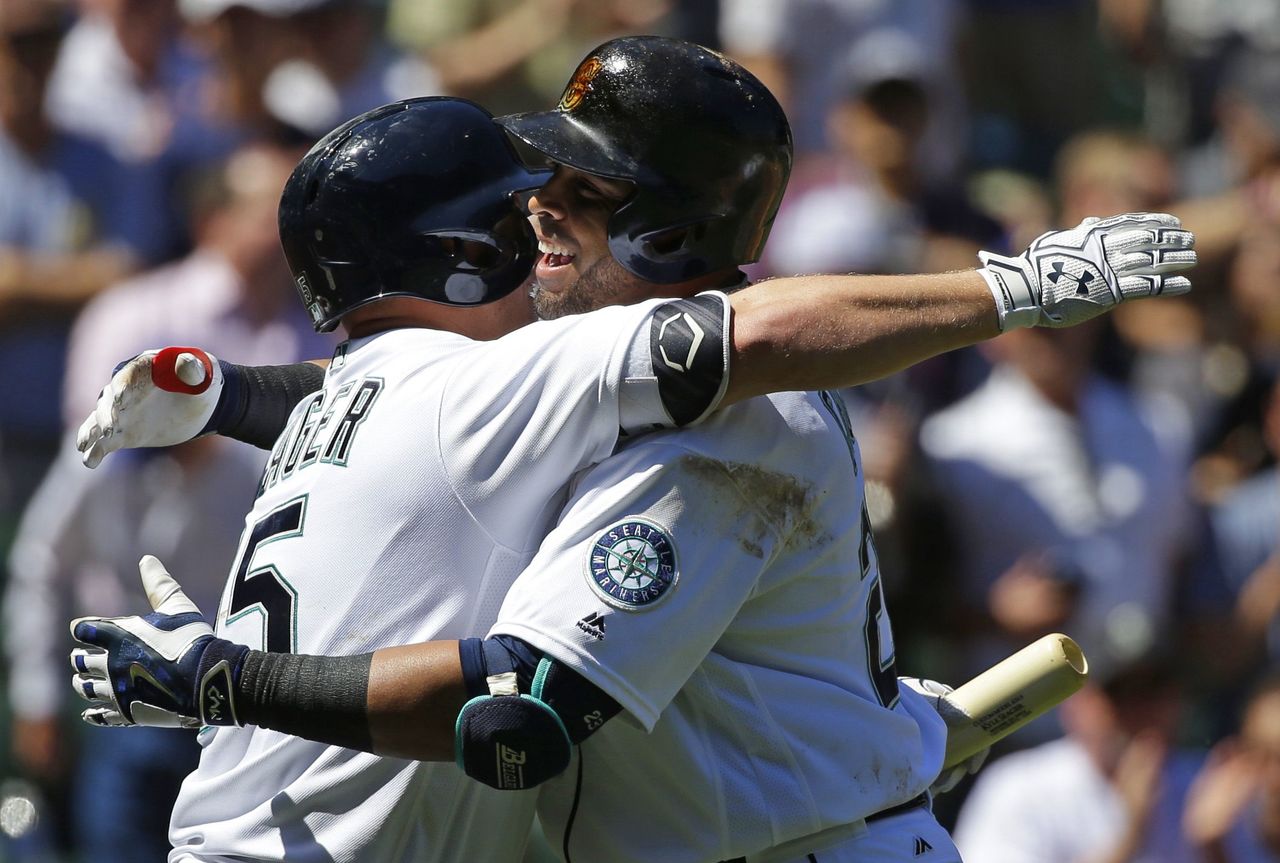 Seattle’s Nelson Cruz (right) gets a hug from teammate Kyle Seager after hitting a home run Wednesday against the Rays.
