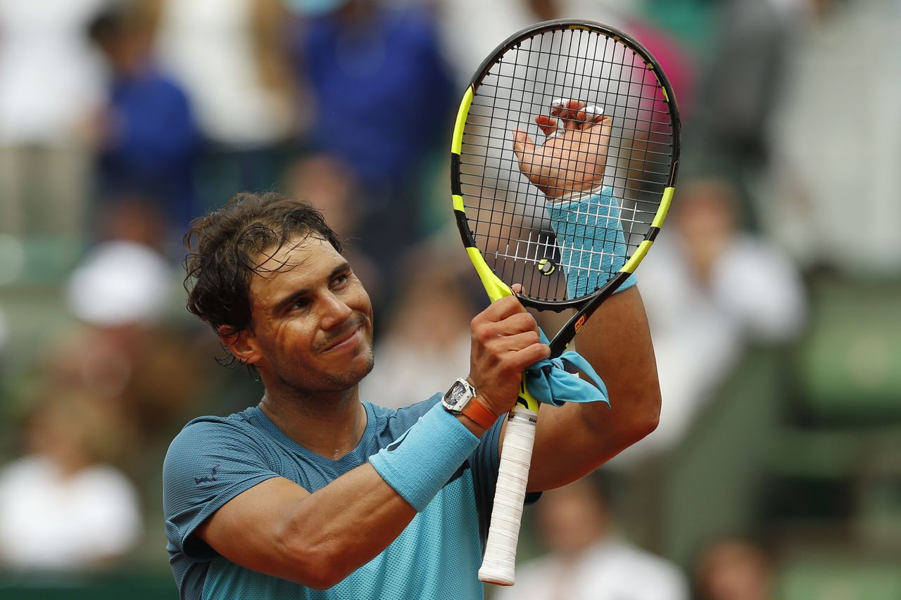 Spain’s Rafael Nadal acknowledges cheering spectators Thursday after winning his second-round match at the French Open tennis tournament in Paris.