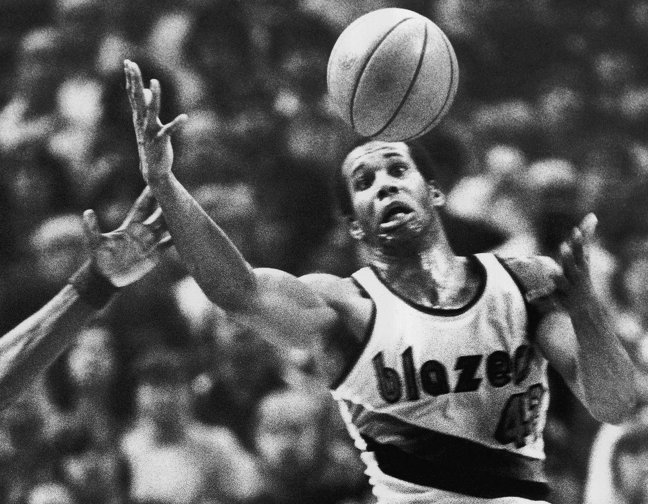 In this photo from Dec. 25, 1979, Kermit Washington gains control of a loose ball during an NBA game against the Golden State Warriors in Portland, Oregon. Washington was arrested Tuesday in Los Angeles. He is accused for using charity money for personal gain.