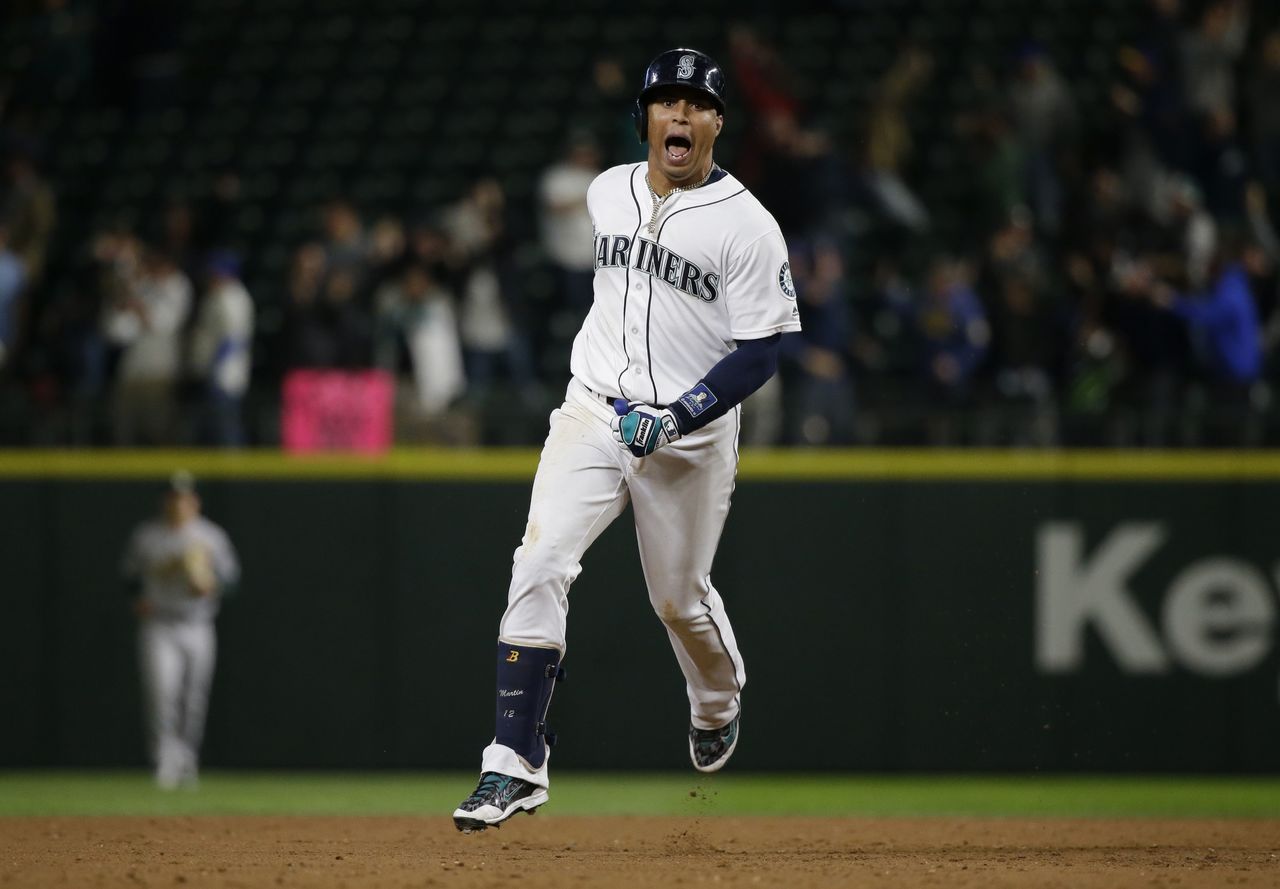 The Mariners’ Leonys Martin celebrates as he rounds the bases after hitting a two-out, two-strike, two-run walk-off home run in the bottom of the ninth inning in Tuesday night’s game against the Oakland Athletics. The Mariners won 6-5.
