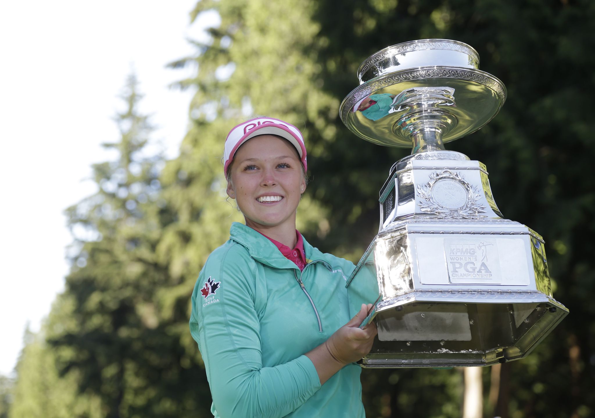 Canada’s Brooke Henderson holds the championship trophy after winning the Women’s PGA Championship golf tournament at Sahalee Country Club Sunday in Sammamish. Henderson defeated Lydia Ko on the first playoff hole.