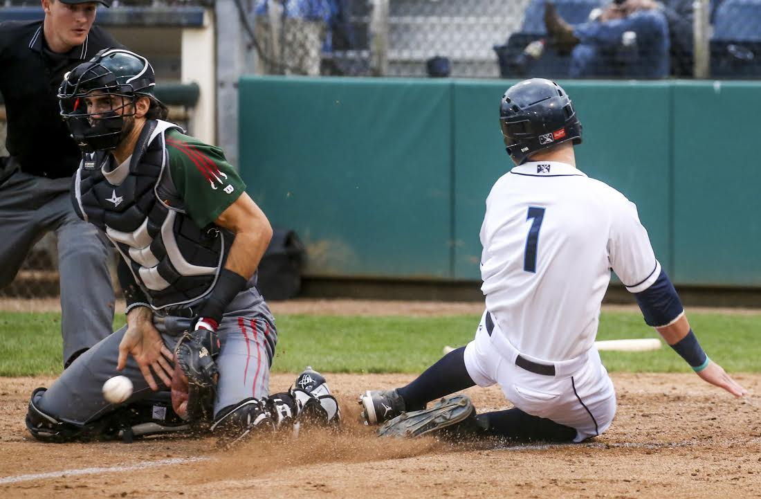 Everett’s Jordan Cowan slides safely past Boise catcher Will Haynie during Thursday night’s game at Everett Memorial Stadium.