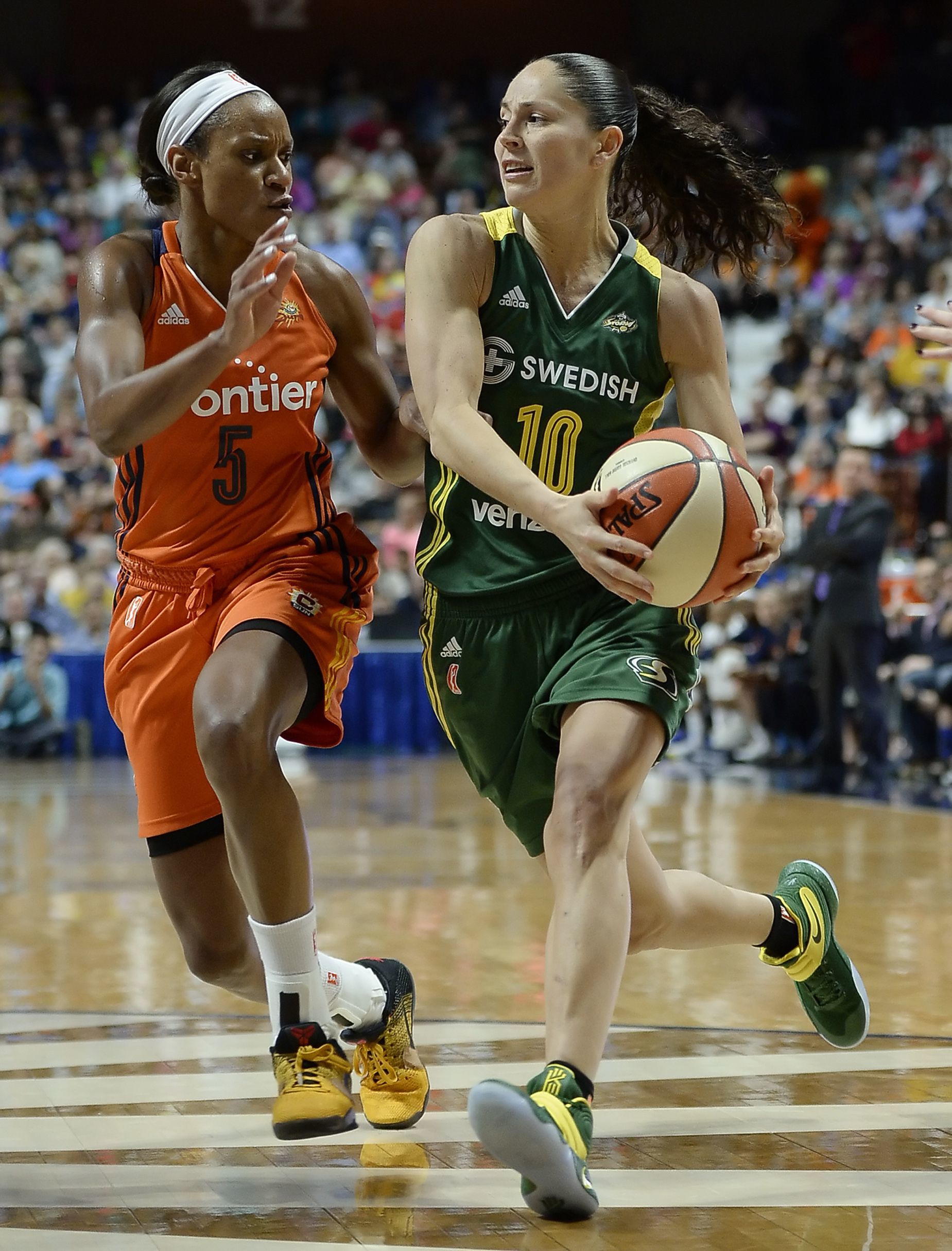 Seattle Storm guard Sue Bird (right) drives to the basket as Connecticut Sun’s Jasmine Thomas defends during the second half of a WNBA game on June 10 in Uncasville, Conn.