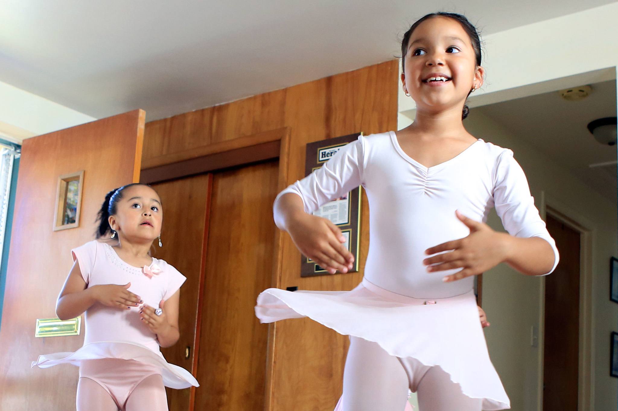 Herald Devani Padron, left, and Daisy Ramos perform during dance class at Mari’s Place in Everett on July 13. (Kevin Clark / The Herald)