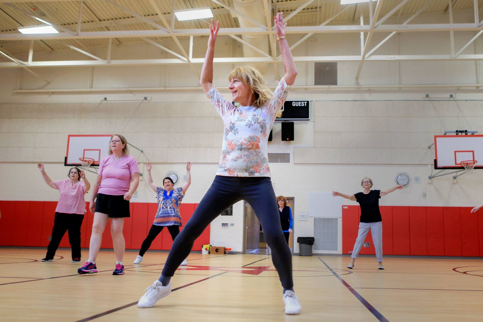Vicki Venolia leads an aerobics class at North Middle School on Wednesday morning in Everett. The Carl Gipson Senior Center is closed for renovations, leaving several programs to find new homes for the summer. The center is scheduled to reopen at the end of August. (Kevin Clark / The Herald)