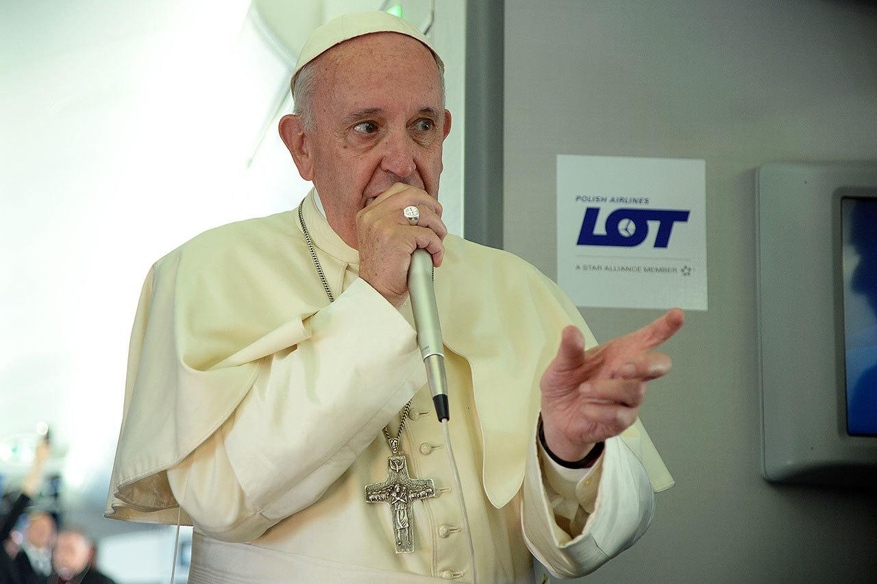 Pope Francis answers reporters questions on board the flight from Krakow, Poland, to Rome, at the end of his 5-day trip to southern Poland on Sunday. (Filippo Monteforte / Associated Press)