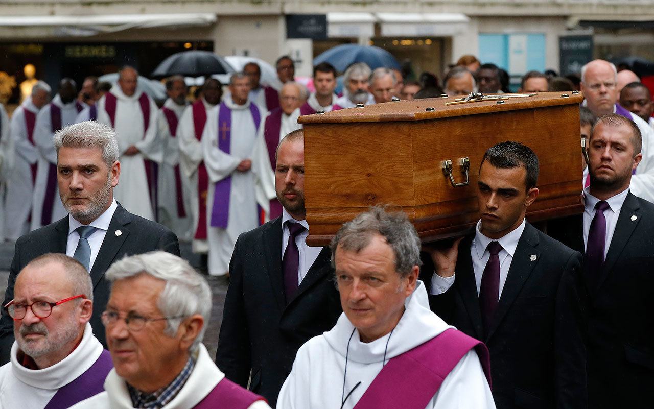 The coffin of Father Hamel is carried outside the Rouen cathedral, Normandy, before his funeral mass Tuesday. Father Jacques Hamel, 85, was killed by two Islamic extremists last week in his church as he celebrated morning Mass. The Islamic State group claimed responsibility for the attack. (AP Photo/Michel Euler)