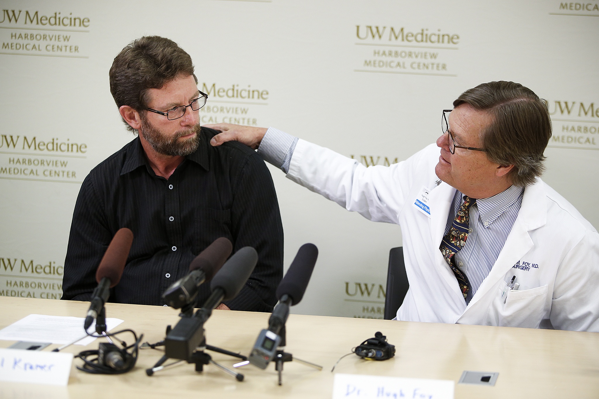 Paul Kramer (left), father of Mukilteo shootings survivor Will Kramer, is comforted by Dr. Hugh Foy, a surgeon at Harborview Medical Center, following a press conference held at the hospital in Seattle on Tuesday afternoon. Will Kramer, 18, is listed as being in satisfactory condition after first spending days in intensive care. (Ian Terry / The Herald)