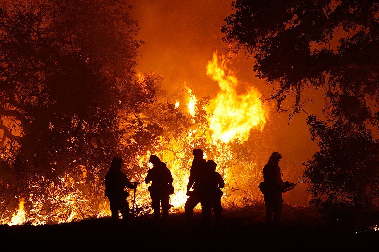 Cal Fire captain Gino DeGraffenreid monitors a firing operation with his crew of firefighters, west of Cachagua, California, on Aug. 2. (Vern Fisher / Monterey Herald)