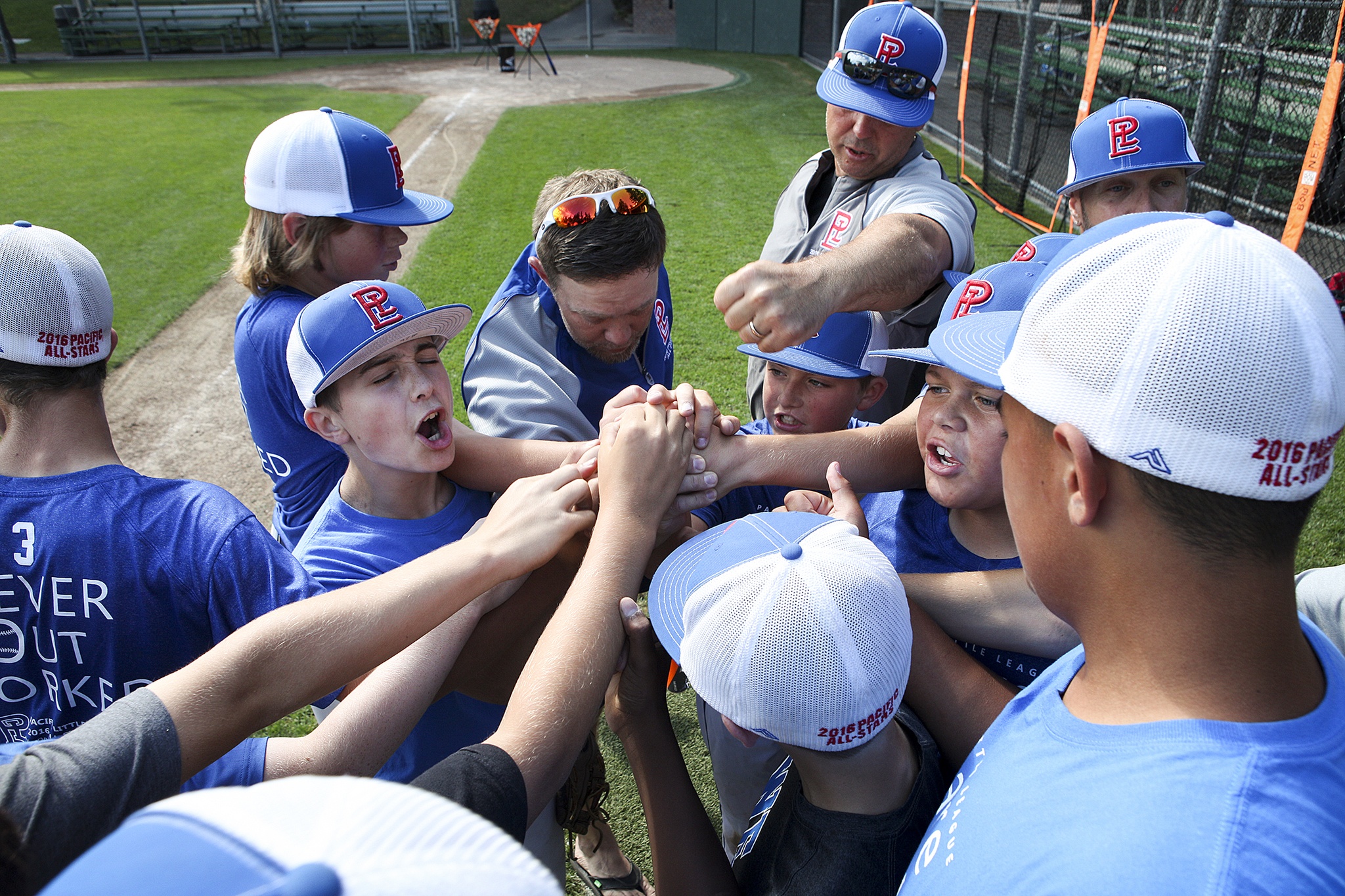 Members of the Pacific Little League All-Star team cheer before taking the field for a practice on Tuesday at Lynndale Park in Lynnwood. The team is headed to San Bernardino for the regional tournament after winning the Washington State Little League Tournament. (Ian Terry / The Herald)