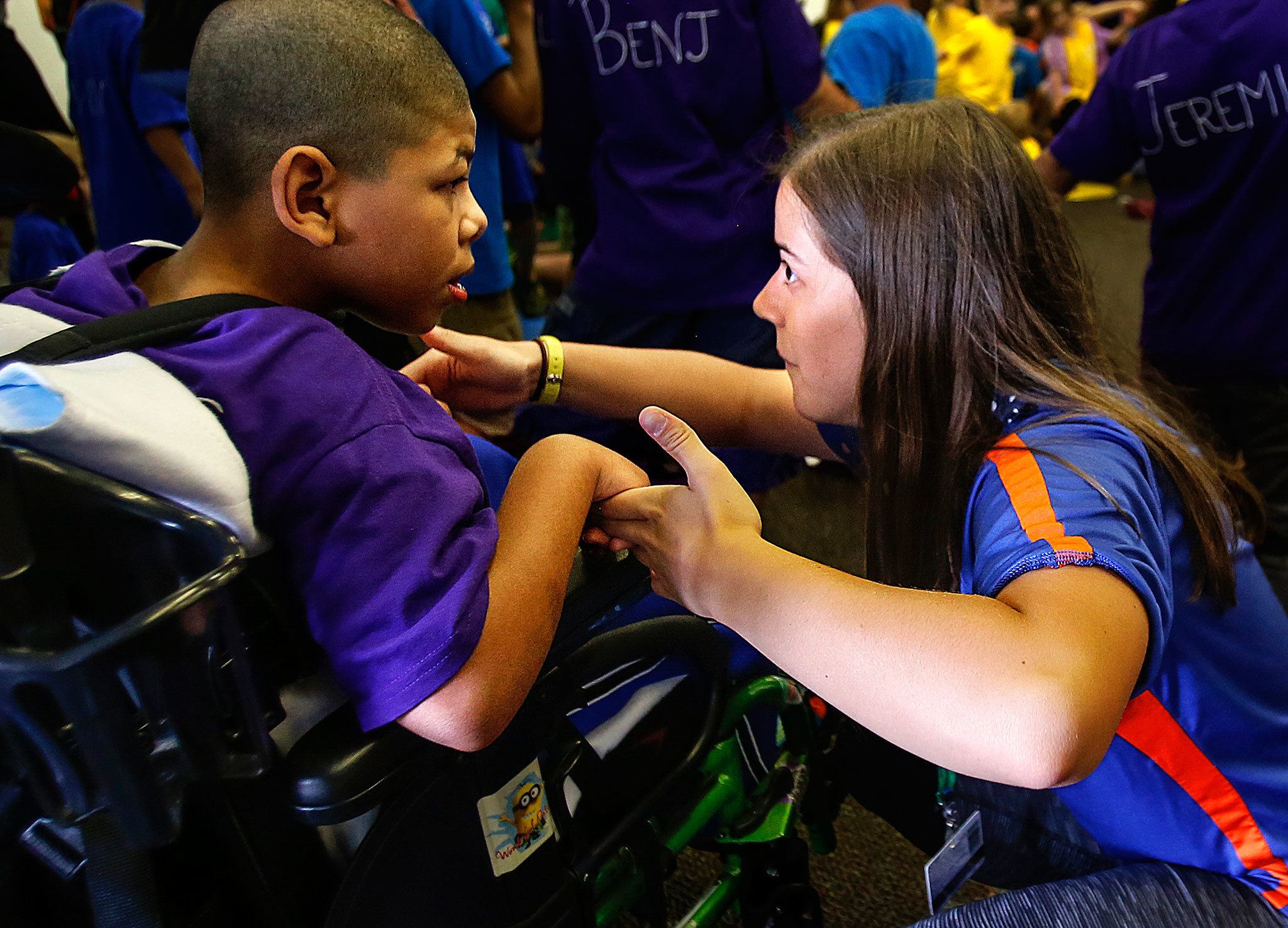While other youngsters and their buddies gather almost ceremoniously at the opening of Wednesday’s Camp Prov, Unit Leader, Casey Wilson, 18 (right) focuses on communicating with Jamarious “Jammers” Carpenter, 8. Later in the day, Casey helped Jamarious in the swimming pool as well. (Dan Bates/The Herald)