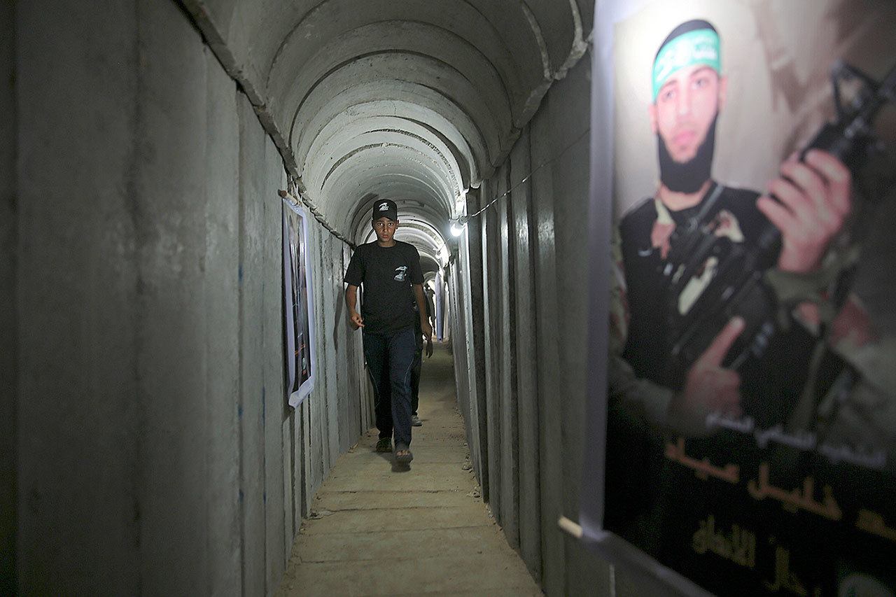 FILE — In this July 20, 2016 file photo, a Palestinian youth walks inside a tunnel used for military exercises during a weapon exhibition at a Hamas-run youth summer camp, in Gaza City. The international charity World Vision says Israel has accused it’s Gaza director of diverting sums to Hamas that exceed its total budget. Israel’s Shin Bet security agency says Mohammed el-Halabi confessed to siphoning about $7.2 million a year to Hamas over a period of five years. Israel indicted el-Halabi Thursday, Aug. 4, 2016. World Vision says this figure is more than its total budget of $22.5 million over the last decade. Building supplies intended to support farming projects were transferred to Hamas for constructing tunnels and military installations, according to the Shin Bet. (AP Photo/Adel Hana, File)                                In this July 20 photo, a Palestinian youth walks inside a tunnel used for military exercises during a weapon exhibition at a Hamas-run youth summer camp, in Gaza City. (AP Photo/Adel Hana)