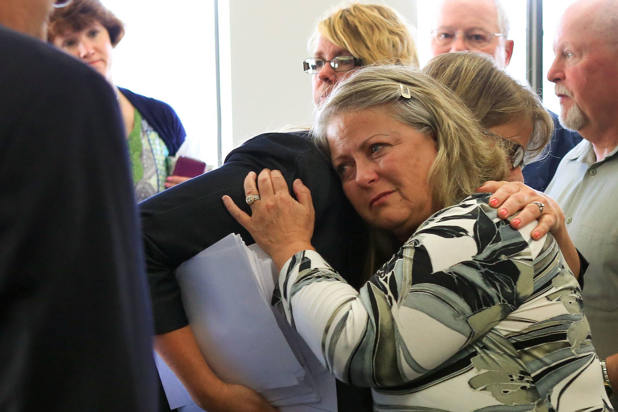 Snohomish County deputy prosecutor Julie Mohr hugs Denise Webber, Rachel Burkheimer’s mother, on Wednesday afternoon at the county courthouse in Everett. (Kevin Clark / The Herald)