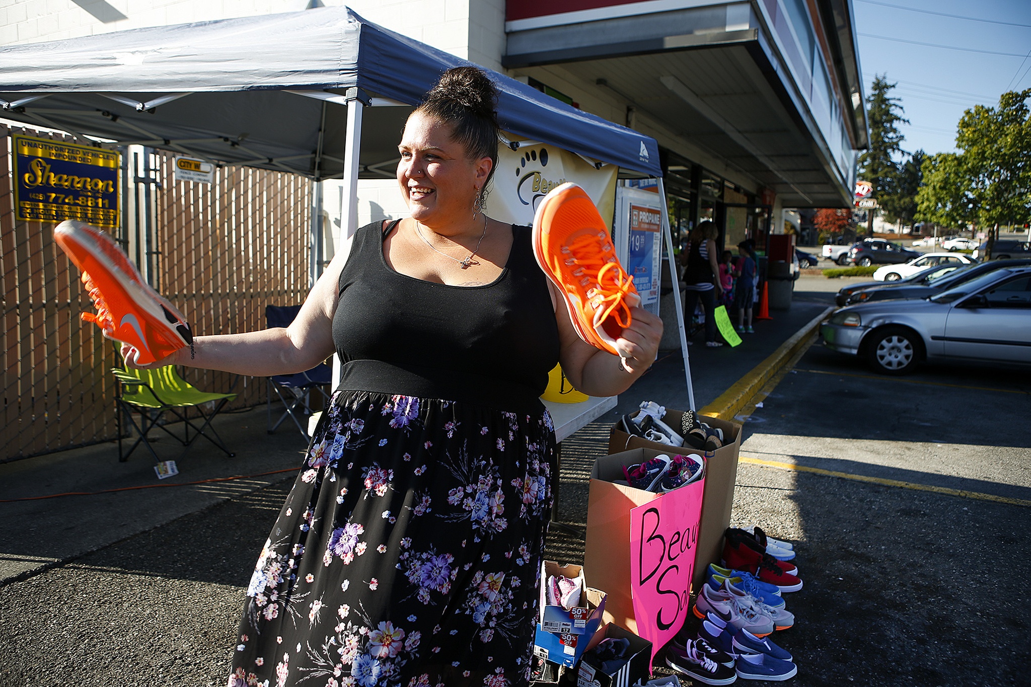 Demetria Lund holds a pair of Nike shoes donated to her Beautiful Soles shoe drive in Lynnwood on Friday, Aug. 5. Since starting the group, Lund has given over 2,400 kids in need a brand new pair of shoes. (Ian Terry / The Herald)