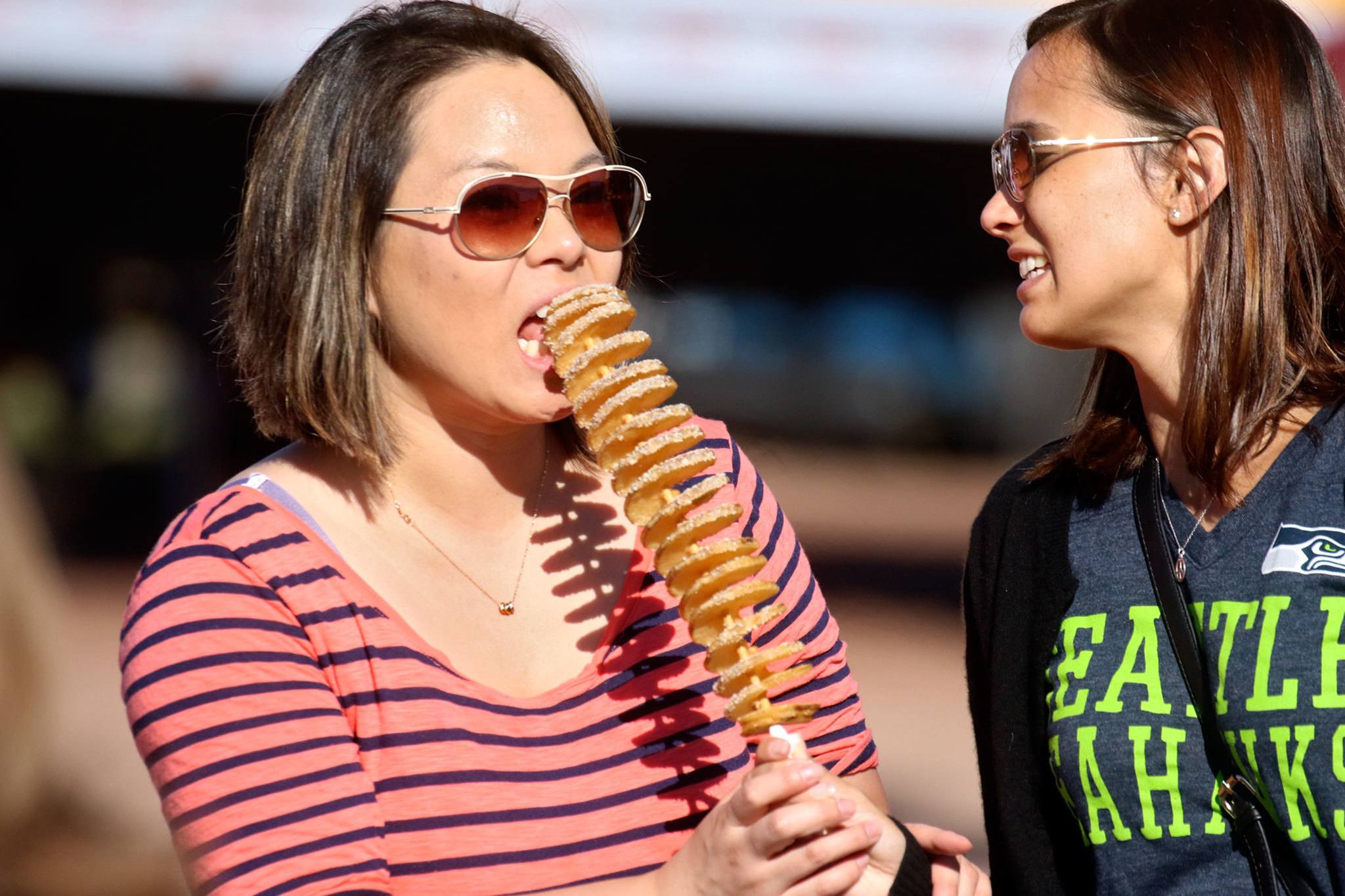 Ahram Hwang (left) takes a bite of Carrie Young’s treat during the annual of Taste of Edmonds on Friday afternoon in downtown Edmonds.(Kevin Clark / The Herald)
