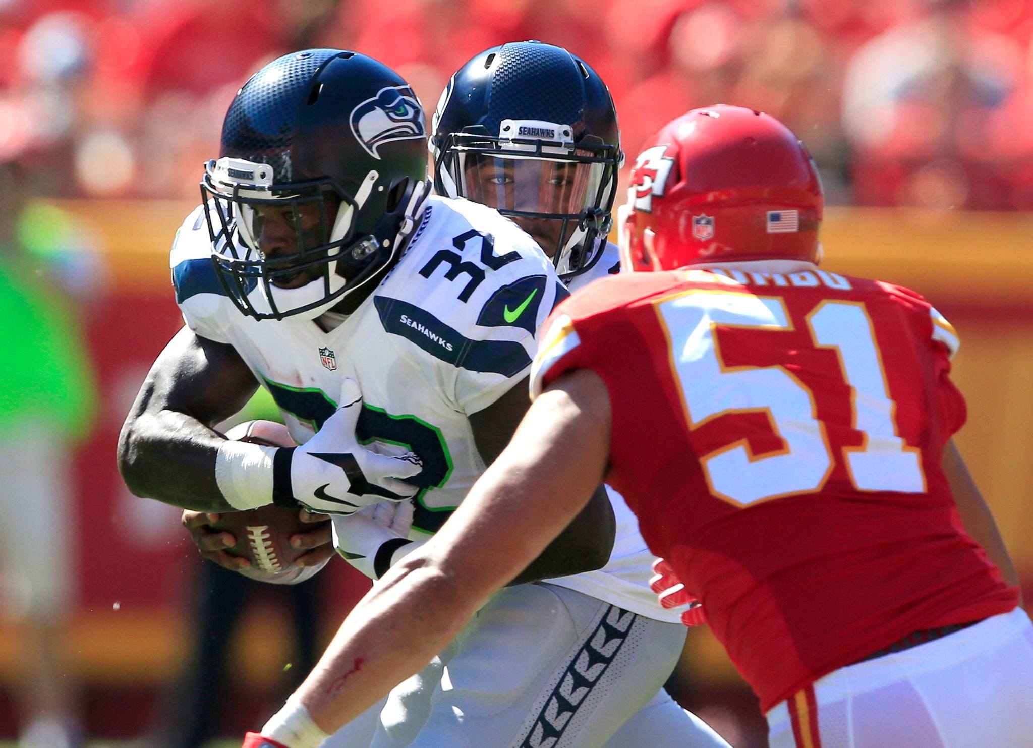 Seahawks running back Christine Michael (32) receives the handoff from quarterback Trevone Boykin (rear) as Chiefs linebacker Frank Zombo (51) pursues during the first half of a preseason game Saturday in Kansas City, Mo. (AP Photo/Orlin Wagner)