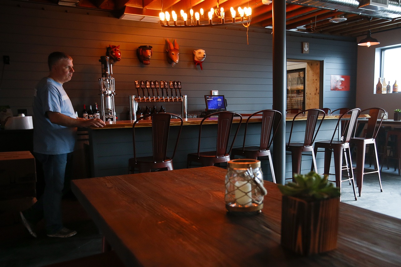 Matt Stromberg, Head Brewer at Scuttlebutt Brewing, stands at the end of their new taproom’s bar at the Cedar Street brewery location in Everett on Tuesday, Aug. 9, 2016. (Ian Terry / The Herald)