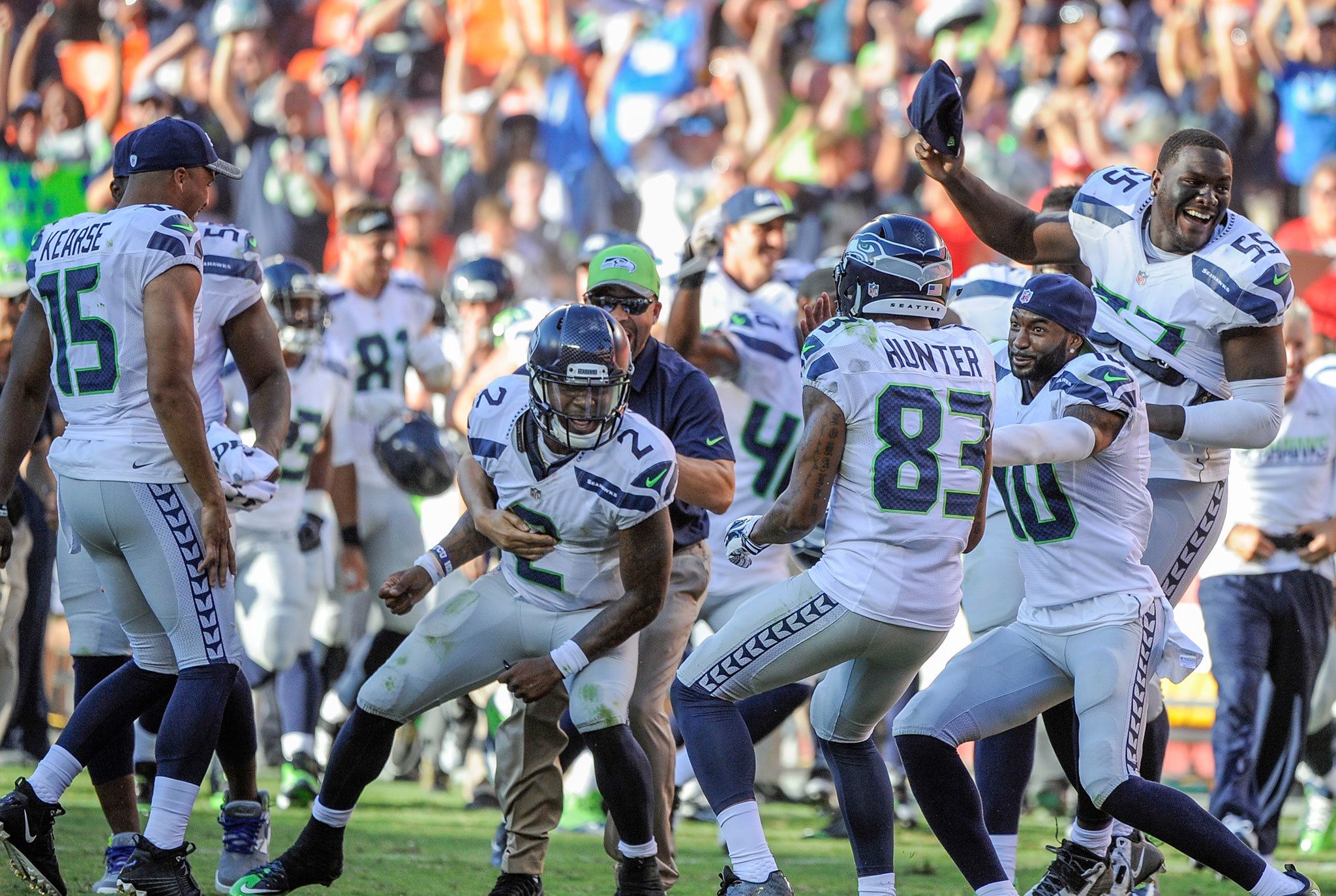 The Seahawks, including backup quarterback Trevone Boykin (2) and defensive end Frank Clark (55), celebrate after running back Troymaine Pope scored on a two-point conversion with no time left in the second half to lift Seattle to a 17-16 victory over the Kansas City Chiefs in a preseason game. (AP Photo/Ed Zurga)