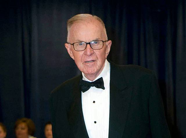 In this April 28, 2012, photo, John McLaughlin arrives at the White House Correspondents’ Association Dinner in Washington. McLaughlin, the conservative political commentator and host of the namesake long-running television show that pioneered hollering-heads discussions of Washington politics, died Tuesday, according to the Facebook page for “The McLaughlin Group.” He was 89. (AP Photo/Kevin Wolf, File)