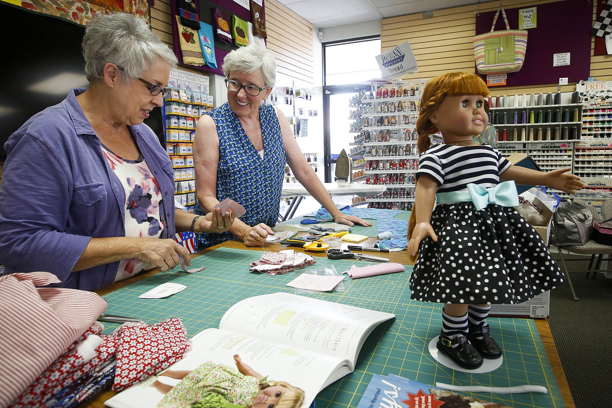 Volunteers are dressing up dolls for Christmas House gifts