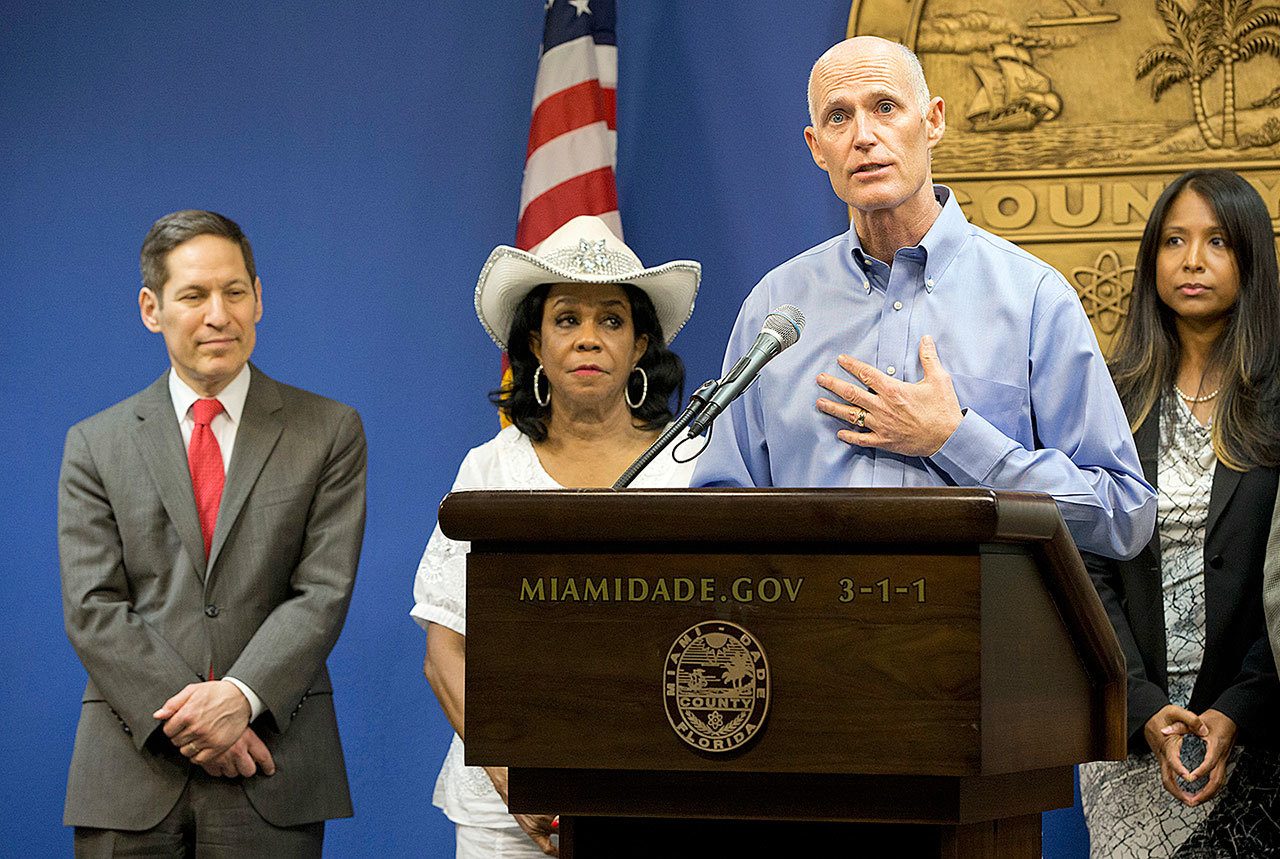 In this Aug. 4 photo, Florida Gov. Rick Scott speaks during a news conference along with Centers for Disease Control and Prevention Director Dr. Tom Frieden, left, Rep. Frederica Wilson, D-FL, and Fla. Surgeon General and Secretary, Dr. Celeste Philip, far right, in Doral, Florida. South Beach has been identified as second site of Zika transmission by mosquitoes on the U.S. mainland, Florida officials said Friday. (AP Photo/Wilfredo Lee)
