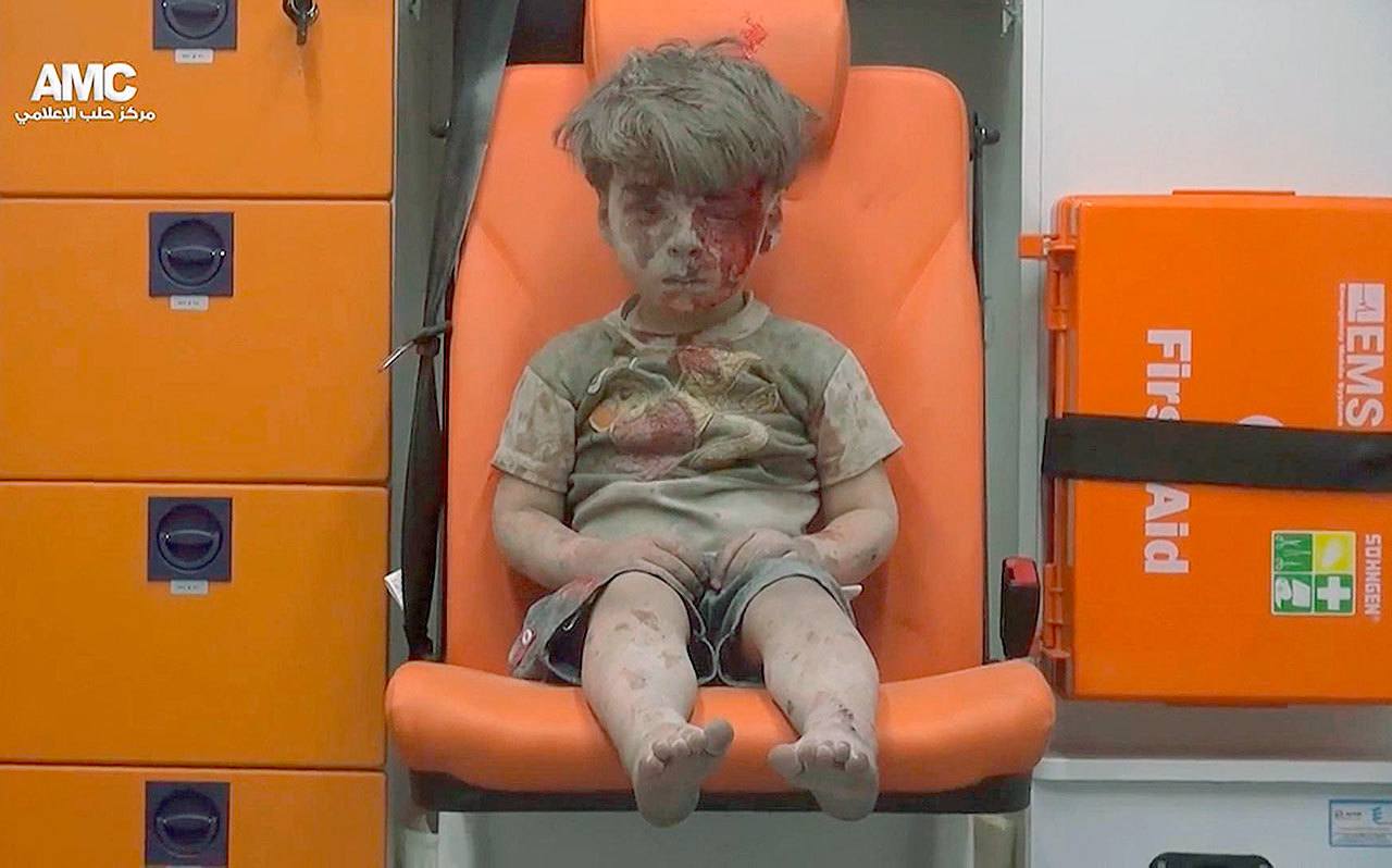 In this frame grab taken from video provided by the Syrian anti-government activist group Aleppo Media Center , 5-year-old Omran Daqneesh sits in an ambulance after being pulled out or a building hit by an airstrike in Aleppo, Syria, on Wednesday. (Aleppo Media Center via AP)