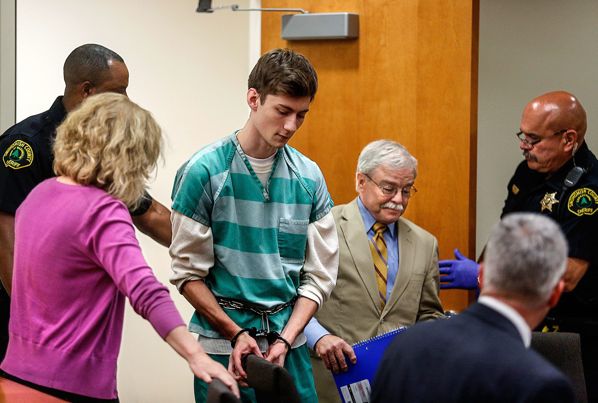 Allen Ivanov, 19, is led into Snohomish County superior court, Monday, where attorneys, Karen Halverson (left) and Walter Peale seat him before Superior Court Judge Thomas J. Wynne to face arraignment. Ivanov is accused of gunning down three former Kamiak High School classmates, including his former girlfriend. (Dan Bates/The Herald)