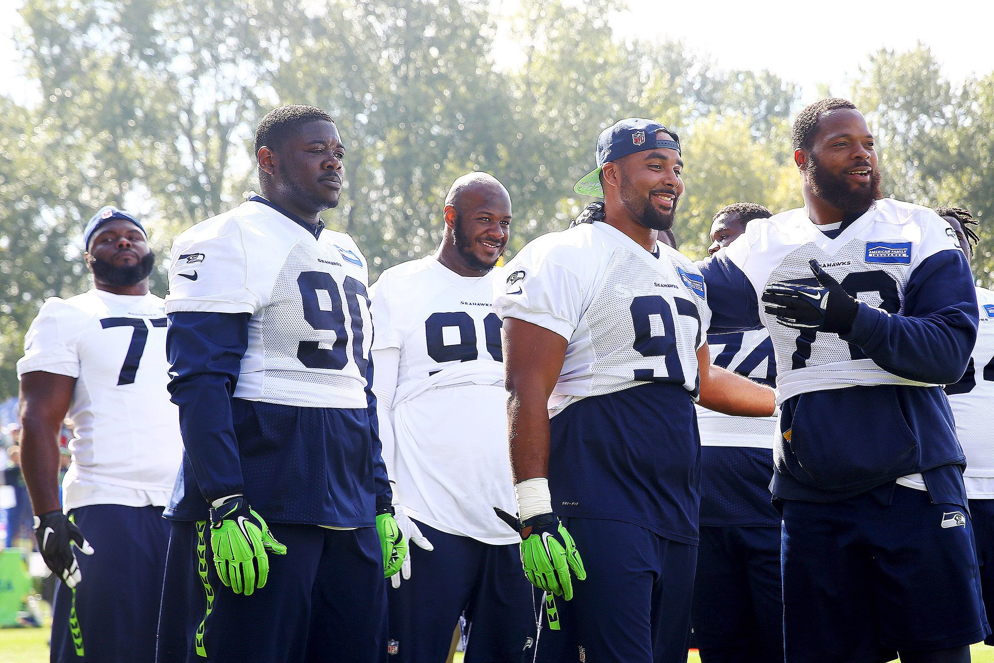 The Seahawks’ Jarran Reed (90), Jordan Hill (97) and Michael Bennett (72) joke between drills during a Seahawks practice last week. (Genna Martin/Seattlepi.com via AP)