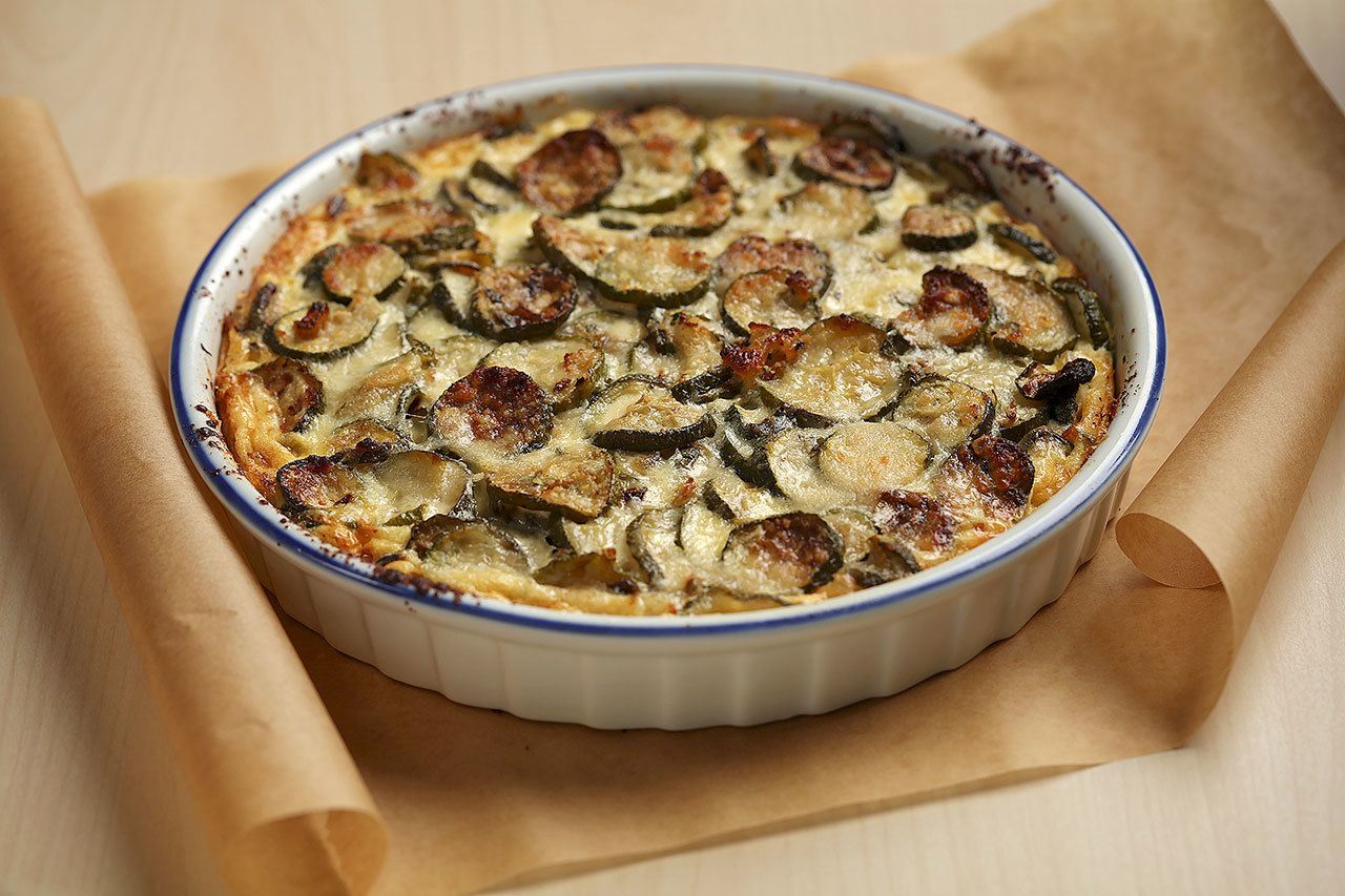 Garden-fresh zucchini is roasted to remove some of the moisture before being mixed into the filling for a savory summer tart. (E. Jason Wambsgans / Chicago Tribune / TNS)