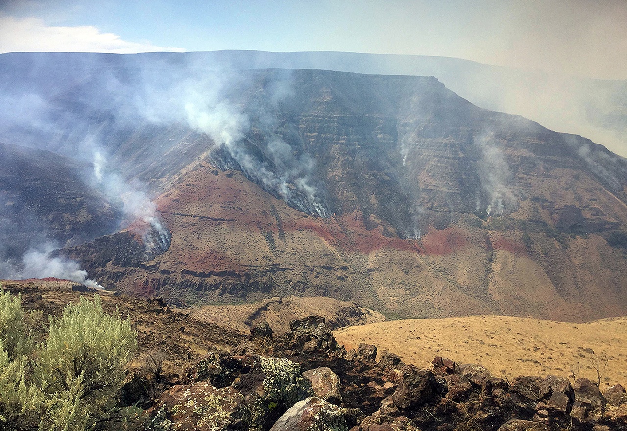 A wildfire smolders on the northwest side of Owyhee Canyon south of Vale, Oregon, on Wednesday. The nearly 50-square-mile fire in eastern Oregon near the Idaho state line is now threatening Succor Creek State Park. (inciweb.nwcg.gov via AP)