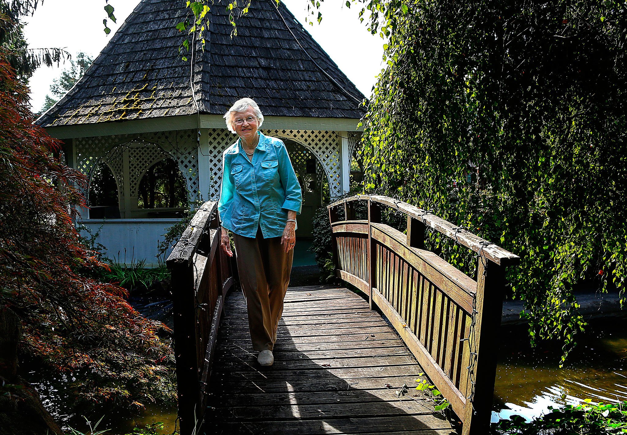Donna Walsh strolls through parts of the 22-plus acre Snohomish Chalet property. Her husband Wally operated the Delta Rehabilitation Center, known locally as the Snohomish Chalet, to help people, who, like their brain-injured son, need care and a good life. (Dan Bates / The Herald)