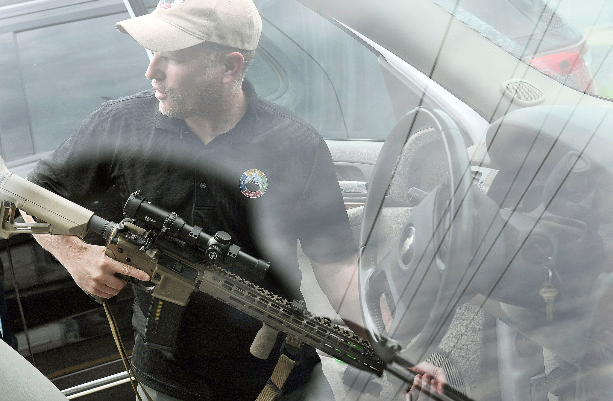 Todd Savage, a retired Marine who moved to north Idaho from San Francisco and opened American Redoubt Realty, displays a firearm that he routinely carries with him in Sandpoint, Idaho. (Matt McClain / The Washington Post)