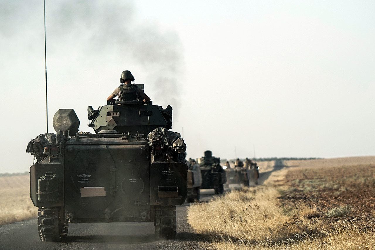 Turkish troops in Karkamis, Turkey, head toward the Syrian border on Saturday. (AP Photo/Halit Onur Sandal)