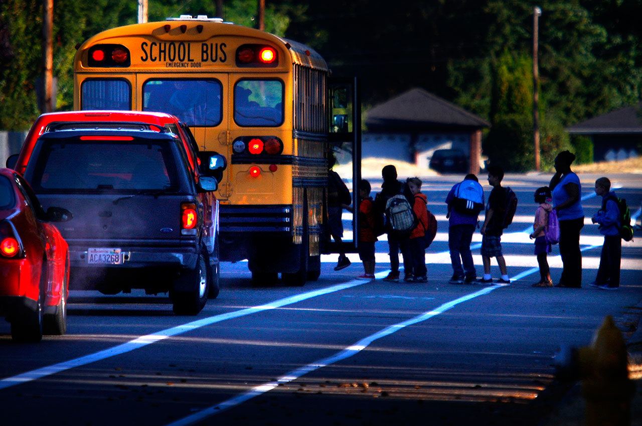 Dan Bates / Herald file photo                                A Marysville school bus picks up children along Cedar Avenue early Wednesday on the first day of school in September 2011.